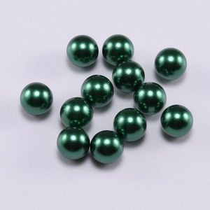 Detailed macro view of 12 dark green round ABS imitation pearls with smooth glossy finish