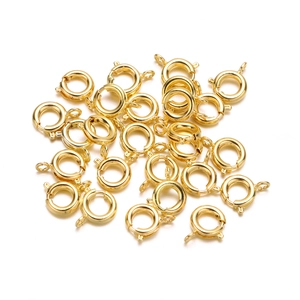 Detailed view of polished gold round spring ring clasps for DIY jewelry making