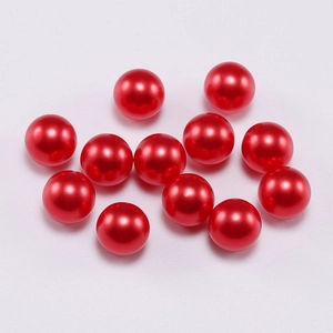 Close-up of vibrant red round ABS faux pearls for DIY jewelry making and crafts