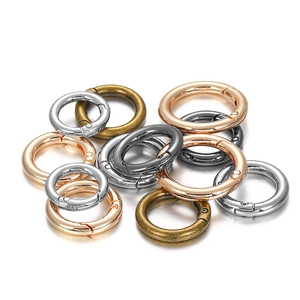 Pile of colorful metal spring O-rings in silver, rose gold, bronze, and gunmetal finishes