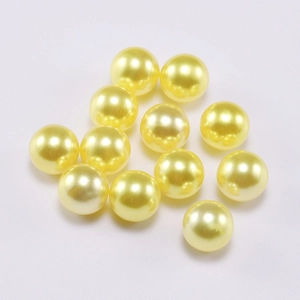 Close-up of vibrant light yellow round ABS faux pearls for DIY jewelry making