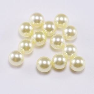 Detailed close-up of 12 ivory round ABS imitation pearls for DIY jewelry and crafts