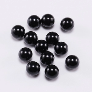 Macro shot of polished black spherical round beads for DIY jewelry making accessories