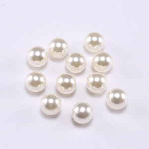 Macro shot of 10 smooth round cream-white ABS loose imitation pearls for jewelry DIY