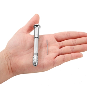 Macro detail of a 0.3-3mm pin vise and micro drill bits held in hand for scale