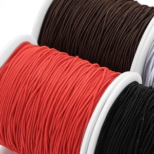 Macro detail of multi-colored elastic cords on spools for sewing and DIY jewelry
