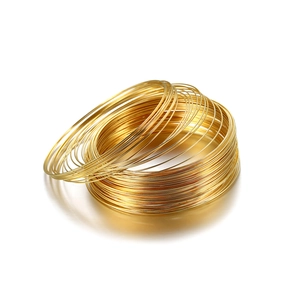 Detail of high-polished gold memory wire coils for DIY jewelry bracelet making
