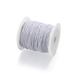 Roll of white elastic cord on plastic spool for DIY jewelry and garment sewing