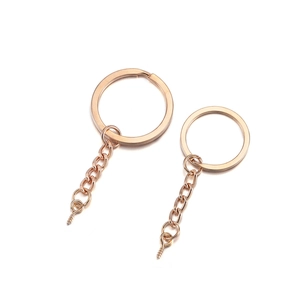 Close-up of rose gold keychain hardware with flat rings, chains and eye screw pins