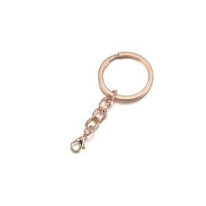 Close-up of golden metal keychain hardware with a flat ring, short chain, and lobster clasp