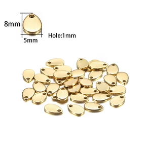 Macro detail of 8x5mm gold stainless steel teardrop charms with 1mm hole for DIY jewelry