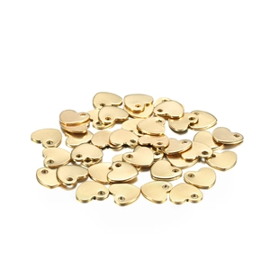 Macro shot of polished gold-finished stainless steel heart charms for DIY jewelry making