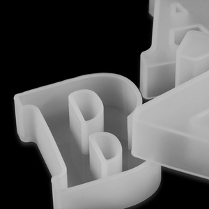 Macro detail of flexible translucent silicone resin mold featuring letters B and A shapes