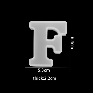 Detail of letter F silicone mold for resin, showing dimensions 6.4x5.3x2.2cm on black background