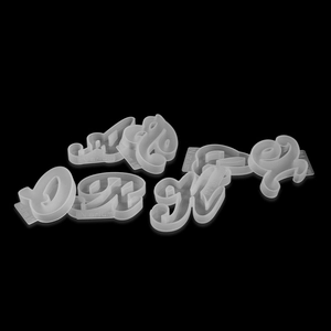 Detail of translucent silicone alphabet molds with reinforced edges on black background
