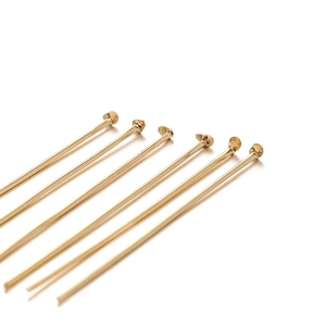 Golden stainless steel ball head pins for DIY jewelry making displayed on a white background