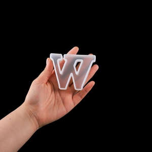 Macro detail of a flexible translucent silicone letter W mold for resin DIY crafts