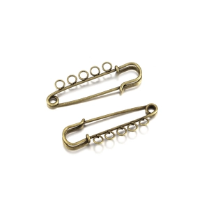 Close-up of vintage bronze safety pins with five loops for DIY jewelry making