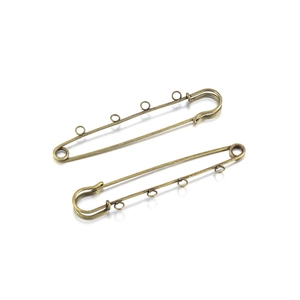 Macro shot of bronze vintage safety pins with four hanging loops for DIY jewelry making