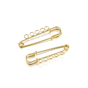 Macro view of gold-plated safety pins with 5 loops for DIY jewelry making accessories