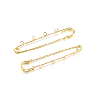 Detail of gold-plated safety pin with four loops for DIY jewelry making and charms