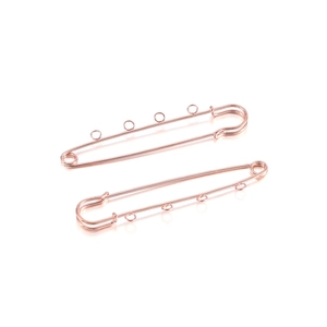 Macro view of rose gold safety pin brooch with three hanging loops for DIY jewelry