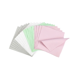 Close-up of microfiber jewelry cleaning cloths with serrated edges in soft pastel colors
