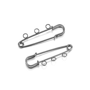 Macro view of silver-toned stainless steel safety pins with three hanging loops for DIY crafts