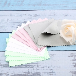 Colorful microfiber jewelry polishing cloths with zigzag edges on vintage blue wood