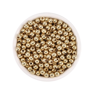 Macro detail of gold plated brass spacer beads with brushed metal texture for jewelry DIY