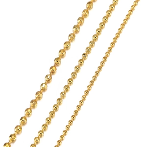 Detailed view of gold ball chains in three sizes with faceted copper bead textures