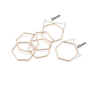 Detail showing golden hexagonal DIY jewelry connectors in sizes 20mm and 22mm on white background
