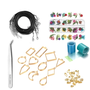 Comprehensive DIY resin jewelry kit with geometric gold frames and dried flower materials