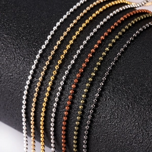Macro detail of multicolored round metal bead chains in gold, silver and rose gold