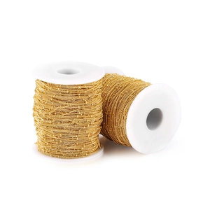 Detail of two spools of shiny gold DIY jewelry craft chains for accessory making
