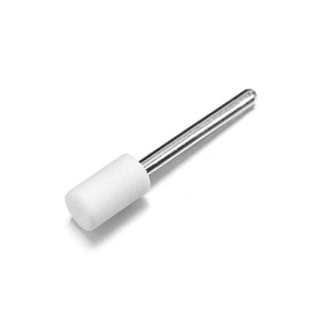 Macro detail of a cylindrical white ceramic nail drill bit with a polished silver shank