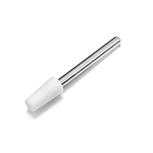 Macro shot of a conical white ceramic nail drill bit with a polished silver metal shank