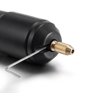Detail of mini electric drill with gold collet and L-shaped hex wrench tool accessory