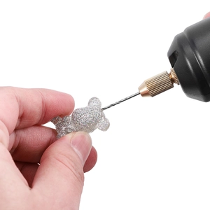Mini electric drill for DIY jewelry making on a silver glitter bear pendant