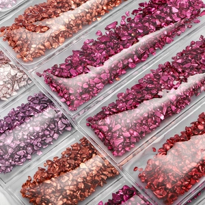 Macro view of metallic rose gold and purple crushed glass sand for DIY resin and nail art