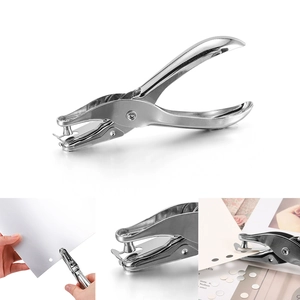 Ergonomic silver metal single hole puncher showing hand operation and paper scrap storage
