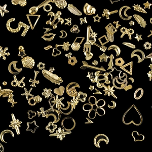 Flat lay of gold mixed metal charms for DIY nail art and resin phone case decoration