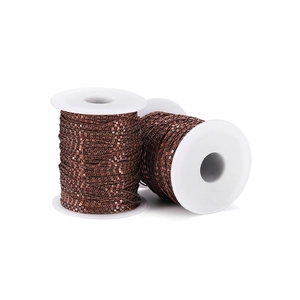 Close-up of 1.6mm copper curb chain rolls for DIY body jewelry making on white spools