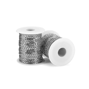 Silver curb chain for DIY jewelry making on white plastic spools for craft projects