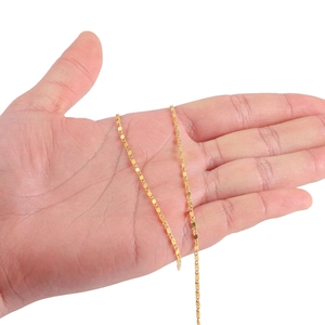 Minimalist 1.6mm golden flat curb chain for DIY jewelry making held in hand for scale