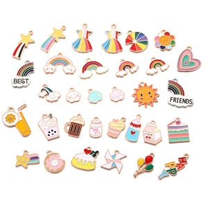 Macro shot of assorted colorful enamel cartoon pendants for DIY jewelry and necklaces