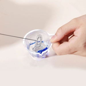 Detail of metal whisk head submerged in liquid for mixing resin and epoxy crafts