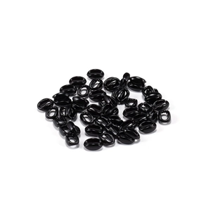 Detail of glossy black coffee bean shaped acrylic beads for DIY necklace chain making
