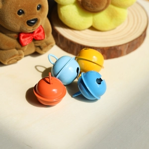 Colorful metal jingle bells in orange, yellow and blue for pet collars and DIY crafts