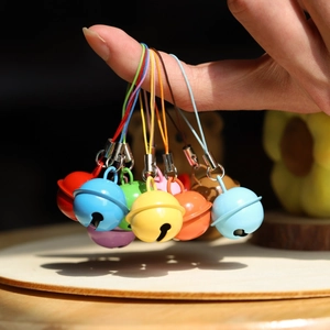 Colorful metal bells set with hanging ropes for DIY keychains and holiday decorations